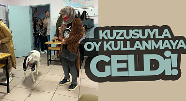 Üzerine kazak giydirdiği kuzusuyla oy kullanmaya geldi