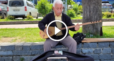 Koyunların peşinde başlayan bağlama sevdasını sahilde küçük konserler vererek sürdürüyor
